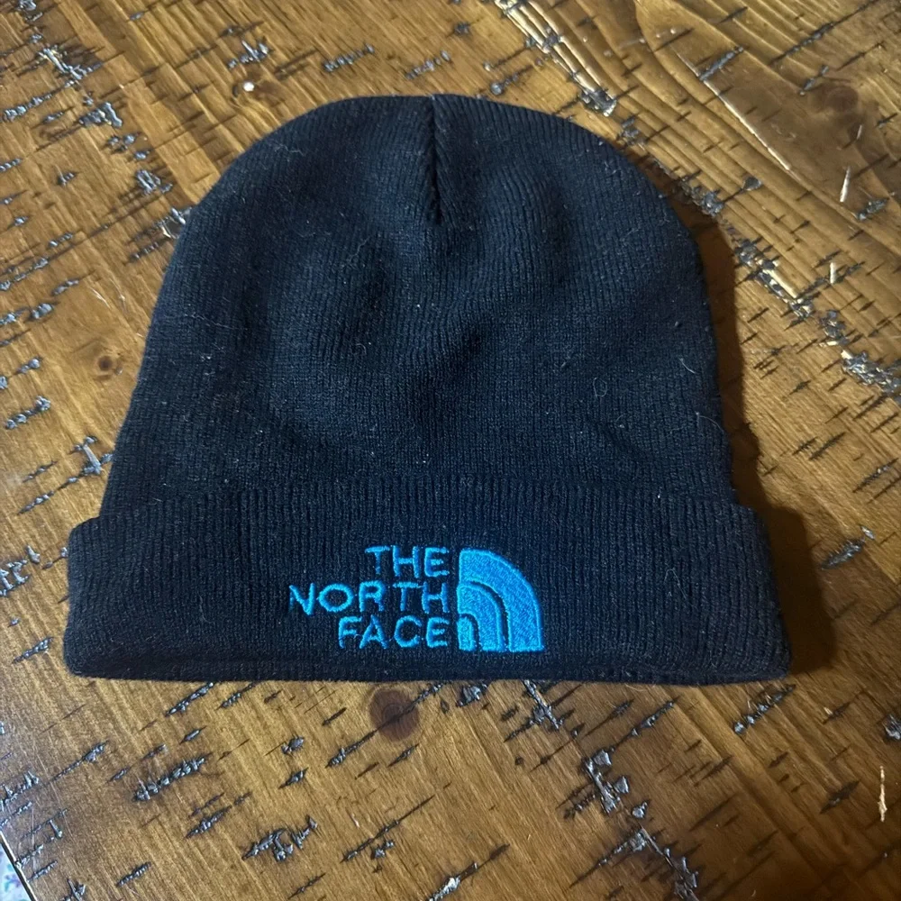 The North Face Black Knit Hat with Blue Logo‎